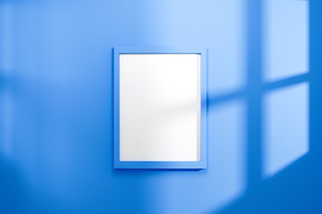 Empty frame on vivid blue wall background with natural light of window. Display of showing exhibition. Realistic 3D render.
