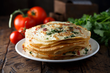 Savory crepes or pancakes with tomato and spinach