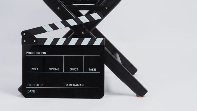 Black Clapper board or movie slate with director chair use in video production or movie and cinema industry.It is put on white background.