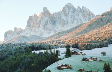 The small village Val di Funes covered in snow, with Dolomites mountains, South Tyrol, Italy. - obrazy, fototapety, plakaty