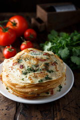 Savory crepes or pancakes with tomato and spinach