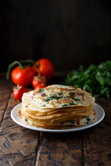 Savory crepes or pancakes with tomato and spinach