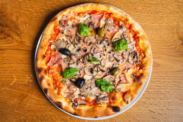 Delicious italian pizza served on wooden table