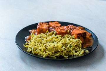 Indian Food Jeera Zira Rice Basmati Pilaf or Pilav with Paneer Butter Tikka Masala / Cheese Cottage Curry.