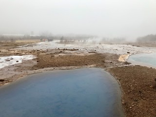 The Blesi Northern Pool, part of Haukadalur, the home of geysers and other geothermal features along the Golden Circle tourist route in southern Iceland on a foggy autumn afternoon