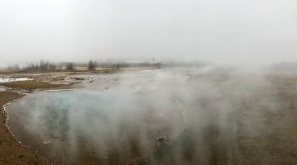 The Blesi Southern Pool, part of Haukadalur, the home of geysers and other geothermal features along the Golden Circle tourist route in southern Iceland on a foggy autumn afternoon