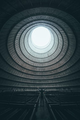 Figure standing inside abandoned cooling tower