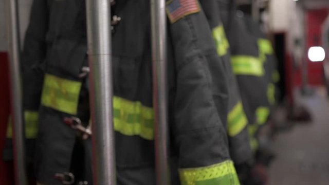 Firefighters' uniforms inside a firehouse