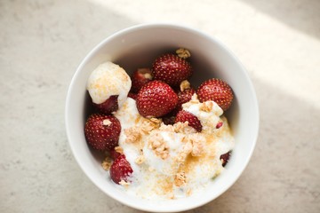 Fresh homemade strawberries for healthy breakfast with white yogurt and musli