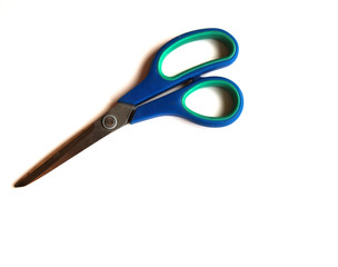 Blue scissors on a white isolated background. Place for text.