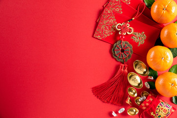 Chinese new year festival decorations pow or red packet, orange and gold ingots or golden lump on a...