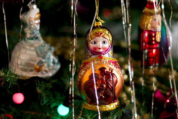 Beautiful christmas tree toys on the brunch of the tree: russian doll matreshka and others