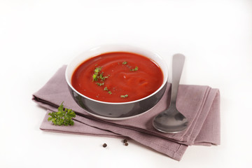 bowl of tomato soup isolated on white background