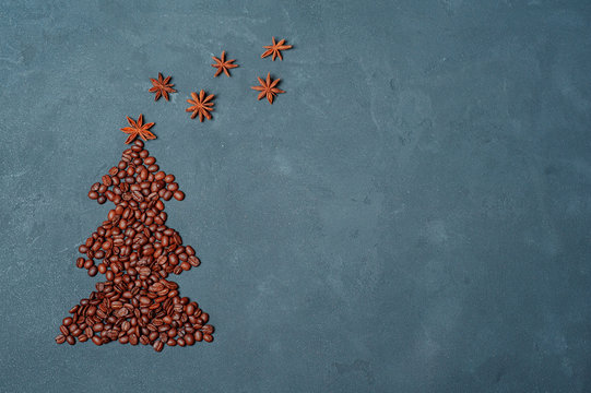 winter composition Christmas tree made by coffee beans with night sky by anise star and chocolate. Greeting card New Year. creativity zero waste concept. Background texture copy space flat lay.