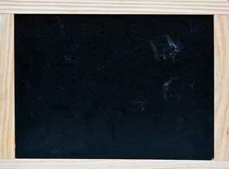 An empty chalk board with a wooden frame.