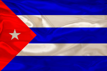 beautiful photo of the colored national flag of the modern state of Cuba on a textured fabric, concept of tourism, emigration, economy and politics, close up