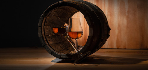 Two glasses of whiskey and an oak barrel