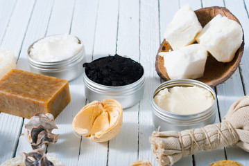 organic skin care butters from, shea, macadamia nut, coffee, mango, and cosmetic clay, mud on white wooden