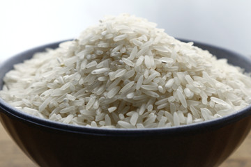 Bowl of raw rice on a table