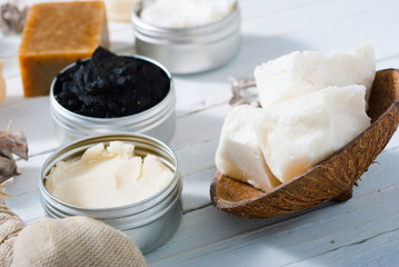 organic skin care butters from, shea, macadamia nut, coffee, mango, and cosmetic clay, mud on white wooden