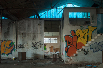 Fototapeta na wymiar Abandoned dirty industry building with graffiti