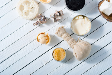 organic skin care butters from, shea, macadamia nut, coffee, mango, and cosmetic clay, mud on white wooden