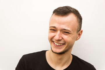 Obraz premium emotion sweat smile, young man on a white background, human emoji