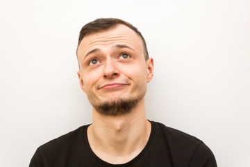 Obraz premium emotion disillusion, young man on a white background, human emoji