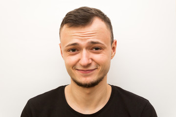 Fototapeta premium emotion smile, young man on a white background, human emoji