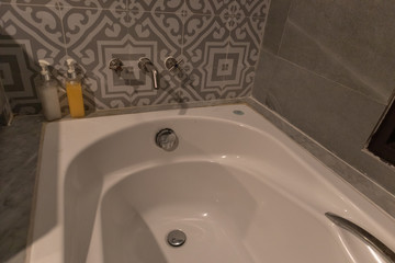 empty white bathtub in bathroom at hotel