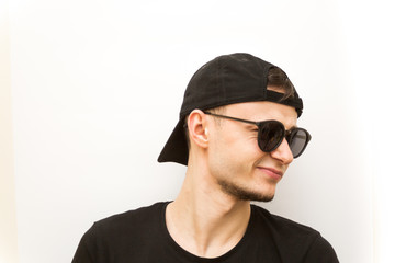 emotion serious, young man in black cap and black glasses on a white background, people emoji