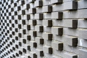 original design solutions in modern urban architecture. wall of a building made of paving slabs.