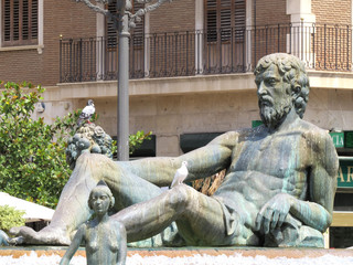 View of the Turia Fountain in the square of Valencia in Spain on a summer sunny day. Neptune statue.
