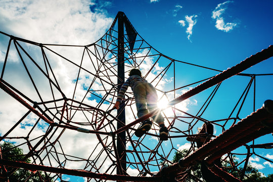 Rope-ladder web in a playground where children can develop their climbing skills and remove fear of heights.