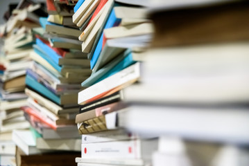 Many used stacked books ready to take to recycle.