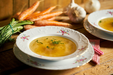 Closeup of delicious home made broth on old wooden table