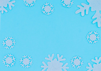 Holiday pastel background, white snowflakes on a gentle blue background ,flat lay, top view. Christmas flatlay copyspace.