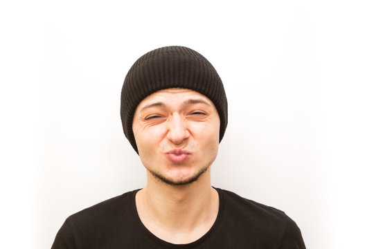 emotion kissing closed eyes, young man in a black cap on a white background, man emoji