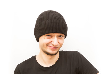 emotion wink, young man in a black cap on a white background, man emoji