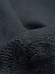 Textile - Fibers close-up showing paterns of the fabric. Soft background and ondulations creating shadows and volumes