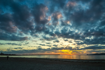Dark clouds over Alghero coast at sunset