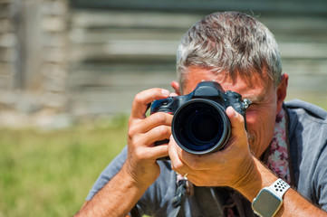 Male photographer observing natural landscape before making pictures