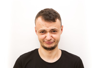 Obraz premium emotion worried, young man in a black cap on a white background, man emoji