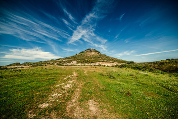 Fototapeta premium Green hill under a blue sky in Sardinia