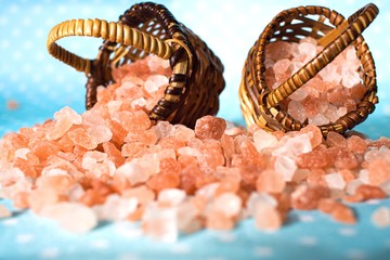 Himalayan Salt on turquoise  surface . Pink spa . in a basket . Salt on the table in the basket