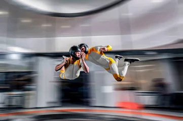 Foto op Plexiglas Extreme sports. Levitation in wind tunnel. Indoor sky diving. Team flyers. Yoga fly in wind tunnel. Indoor skydiving.  © Viktor