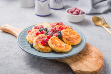 Breakfast with cheesecake,  fresh berries .  Cottage cheese pancakes or curd fritters. Russian syrniki or sirniki