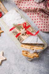 Stollen a traditional European cake with nuts and candied fruit, is dusted with icing sugar and cut into pieces