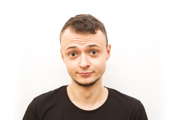 Obraz premium emotion hushed, young man in a black cap on a white background, man emoji