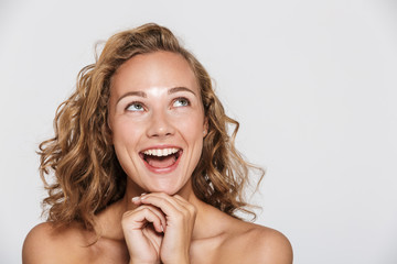 Image of happy half-naked woman laughing and looking upward